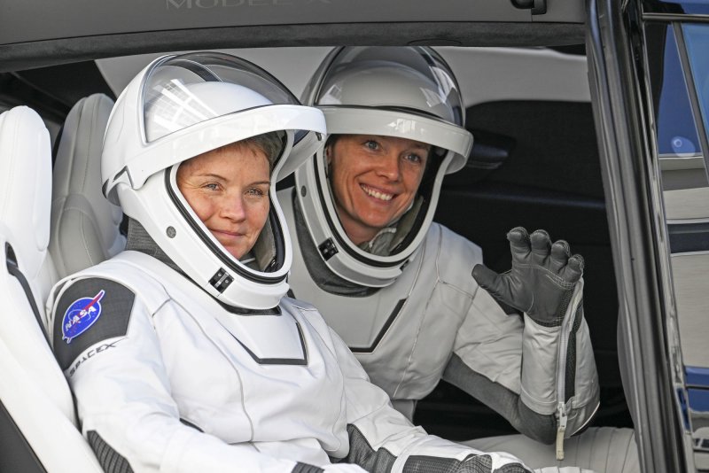 SpaceX NASA Crew-10 members and NASA Astronauts Nichole Ayers (R) and Anne McClain peer out of a Tesla X after walking out of the Neil A. Armstrong Operations and Checkout Building at the Kennedy Space Center in Florida in March. File Photo by Joe Marino/UPI